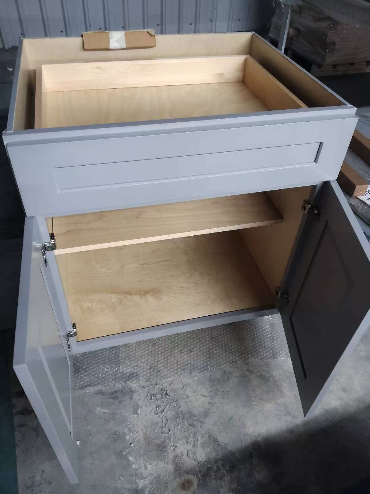 Cabinet with open doors and drawer